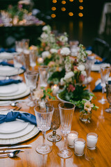 Elegant dining table setup with floral arrangements and soft ambient lighting for a special event celebration