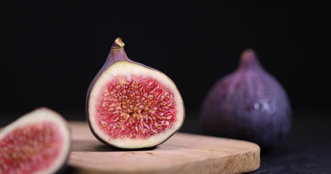 cut fig fruit on a wooden table, sweet fig fruits are used to make desserts