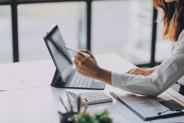 Portrait of young asian woman working with laptop at home office.