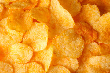 Pile of crispy potato chips close up view