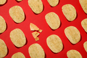 Crispy potato chips on a red background