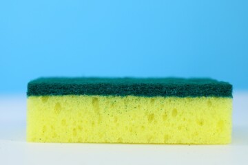 sponge for washing dishes on a light background close up