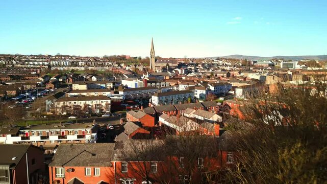 Aerial shot of St Eugene's Cathedral, The Derry Walls and The Creggan area of Derry-Londonderry filmed on a bright sunny day. Filmed in 4K, 60fps and in Rec709 color.