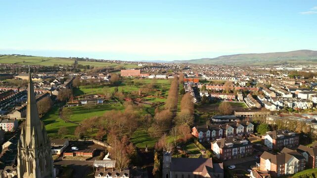Reversing aerial shot of St Eugene's Church and The Creggan area of Derry-Londonderry on a bright and sunny day. Filmed in 4K, 60fps and in Rec709 color.