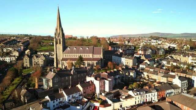 Advancing aerial shot of St Eugene's Church and The Creggan area of Derry-Londonderry on a bright and sunny day. Filmed in 4K, 60fps and in Rec709 color.