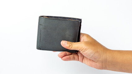A tanned hand holding an ugly and broken wallet on a white background
