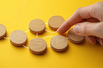 Workflow Automation Process Management with Flowchart and Wooden Tokens on Yellow Background