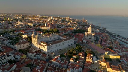 LISBON, PORTUGAL - JANUARY 22, 2025: Aerial view showcasing historic sites and vibrant neighborhoods of Lisbon during sunset
