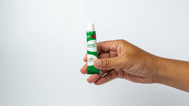 Hand holding genoint. Genoint is an eye drop, eye ointment and skin ointment to help treat inflammation caused by bacterial infections.