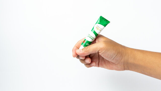 Hand holding genoint. Genoint is an eye drop, eye ointment and skin ointment to help treat inflammation caused by bacterial infections.