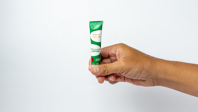 Hand holding genoint. Genoint is an eye drop, eye ointment and skin ointment to help treat inflammation caused by bacterial infections.
