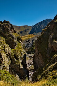 Russia, Elbrus region. The differences of the Kyzylkol mountain river with picturesque valleys and waterfalls at the foot of the highest mountain in the Caucasus - Elbrus (5642 m).