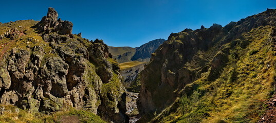 Russia, Elbrus region. The differences of the Kyzylkol mountain river with picturesque valleys and waterfalls at the foot of the highest mountain in the Caucasus - Elbrus (5642 m).