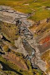 Russia, Elbrus region. The differences of the Kyzylkol mountain river with picturesque valleys and waterfalls at the foot of the highest mountain in the Caucasus - Elbrus (5642 m).