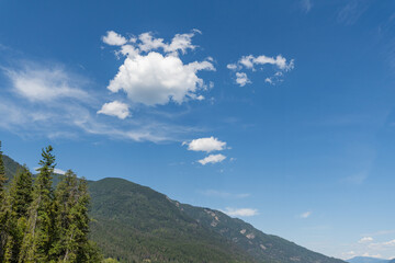 Bright blue sky with fluffy white clouds on a sunny day