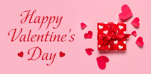 Gift box and paper hearts on pink background. Valentine's Day celebration
