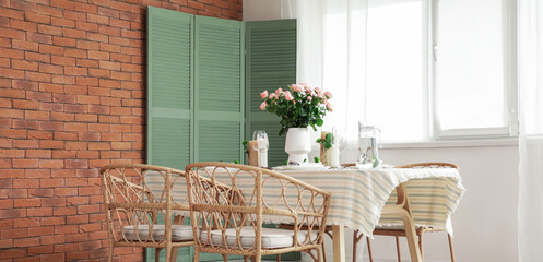 Beautiful table setting with floral decor in dining room