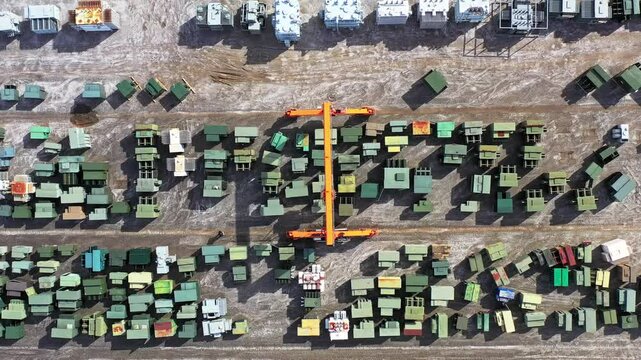 An aerial view of a slow-moving gantry crane surrounded by transformers at Maddox Industrial Transformer in South Carolina.