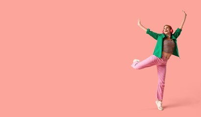 Happy woman in headphones dancing on pink background with space for text