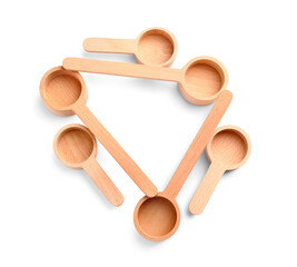 Composition with wooden scoops on white background