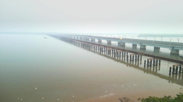 train going from bhayandar staton on vasai creek bridge wide bird eye view