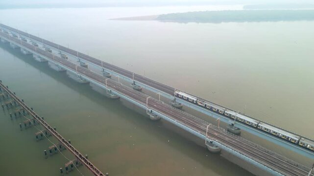 train going from naigoan to bhayandar on vasai creek bridge bird eye view