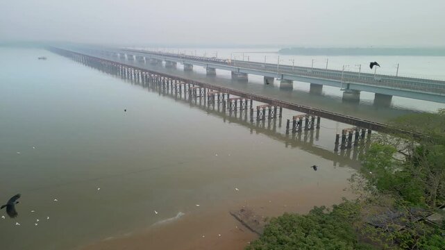 train going from naigoan to bhayandar on vasai creek bridge bird eye view