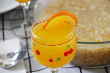 Orange juice served in a glass on a soup background
