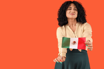 Fototapeta premium Beautiful woman with Mexican flag on orange background