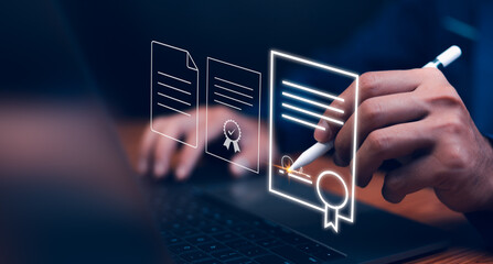 Concept of digital contract innovation. A person uses a stylus to sign a digital document displayed as a glowing hologram above a laptop, symbolizing e-signature and secure online certification.