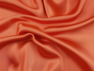 Obraz premium A close-up of luxurious orange fabric, showcasing its smooth texture and rich color, perfect for fashion and design applications.