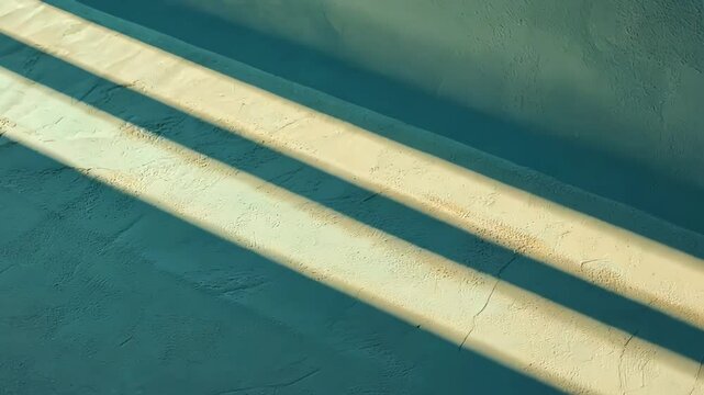 Teal wall with parallel light stripes. Abstract background image perfect for design projects.
