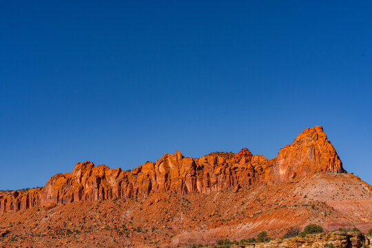 red rock cliffs at the bottom and a large deep blue sky with lots of room for copy