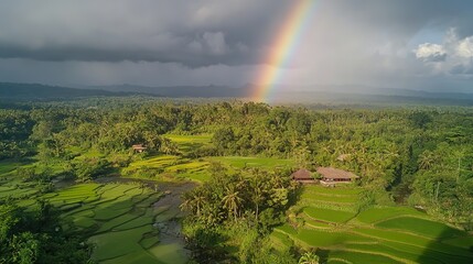 Obraz premium Stunning Rural Landscape with Colorful Rainbow Stretching Elegantly Across the Sky