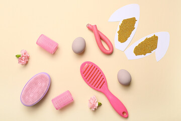 Hairdressing accessories with flowers, Easter egg and bunny ears on beige background