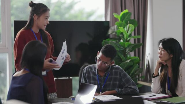 Diverse different aged business team brainstorming in conference room