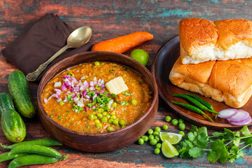 Pav Bhaji is a spicy, mashed vegetable curry served with buttered, toasted bread rolls, commonly enjoyed as a street food.