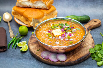 Pav Bhaji is a spicy, mashed vegetable curry served with buttered, toasted bread rolls, commonly enjoyed as a street food.