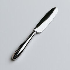 Fototapeta premium Shiny butter knife on white background