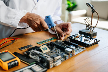 The technician repairing the motherboard in the lab with copy space. the concept of computer hardware,