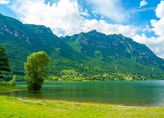 Serene Lake Idro Surrounded by Majestic Mountains and Cloudy sky, Italy, Crone