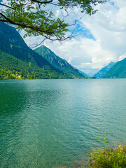 Serene Lake Idro Surrounded by Majestic Mountains and Cloudy sky, Italy, Crone