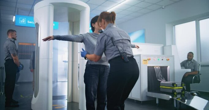 Airport Terminal: Woman Walks Through Metal Detector Scanner Gates on Security Checkpoint. Female Security Officer Checks Passenger for Plane Flight Boarding. Diverse Tourists Going on Holiday Trips.