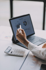 Portrait of young asian woman working with laptop at home office.