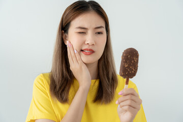 Asian woman feel sensitive teeth after eating ice cream, female suffer tooth, decay problems,...