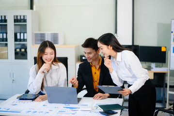 Asian business people discussing business plan at modern startup in creative business discussing work