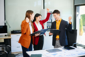 Asian business people discussing business plan at modern startup in creative business discussing work