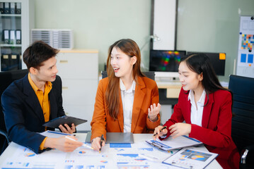 Asian business people discussing business plan at modern startup in creative business discussing work