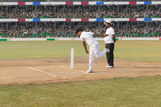 The bowler takes his position and marks out his run-up during the cricket game
