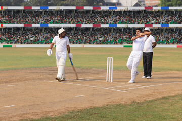 Spin bowler delivers the ball towards the batsman, during the cricket game